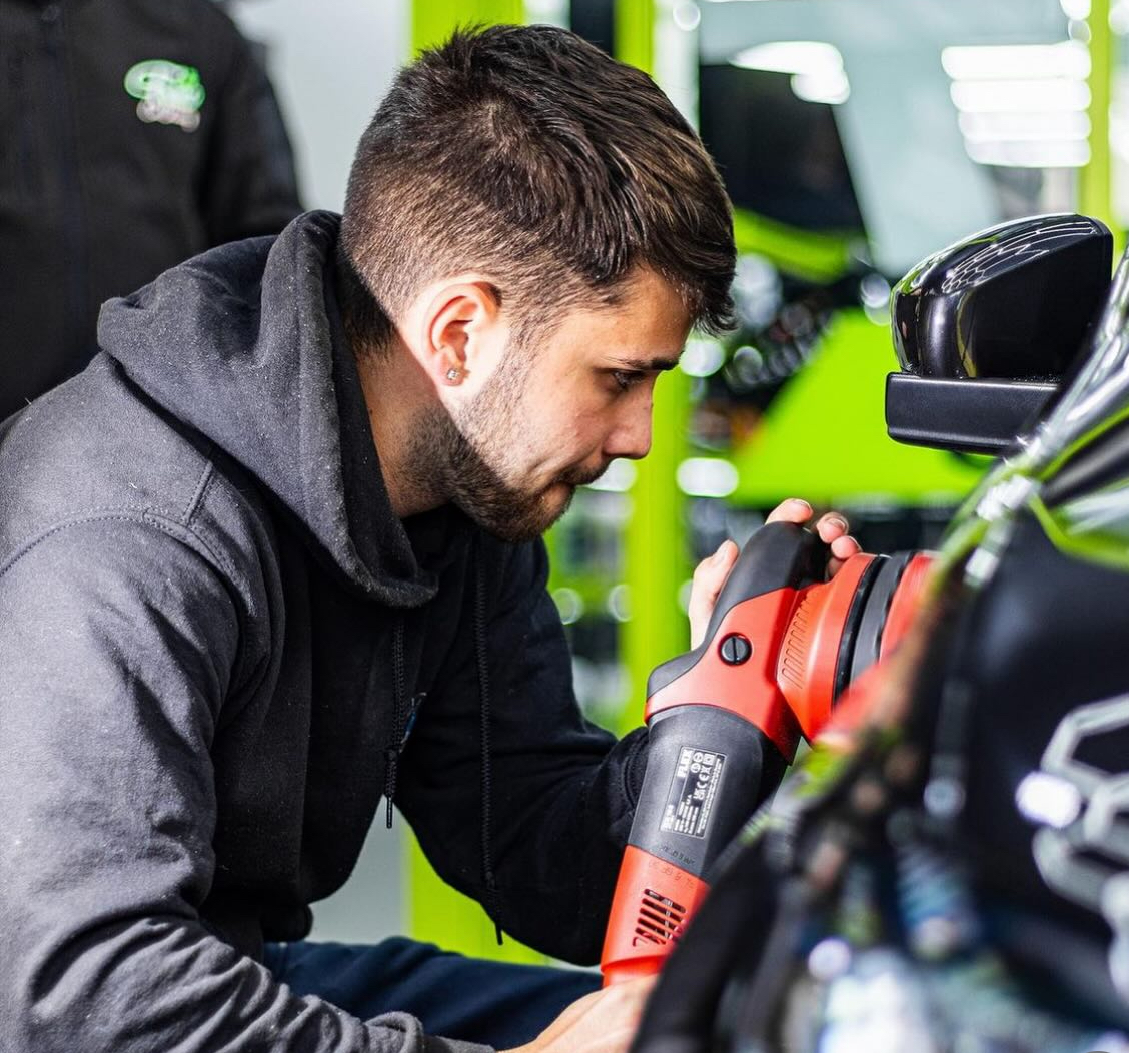 Close-up of machine polishing a black panel