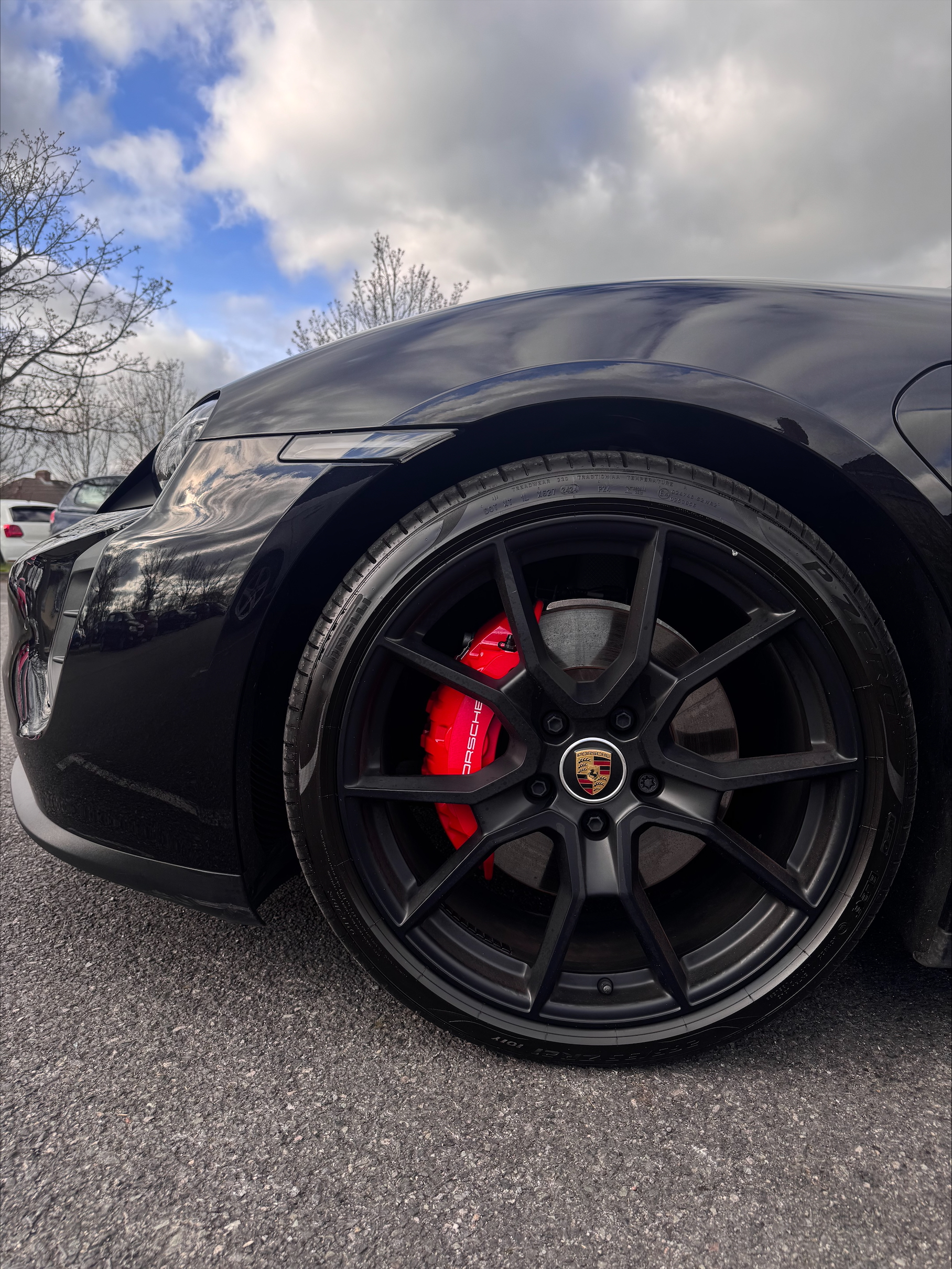 Porsche wheel with red caliper — ceramic coated